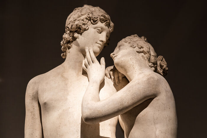 Marble statue of two figures in an intimate pose, symbolizing human connection and emotion in art.