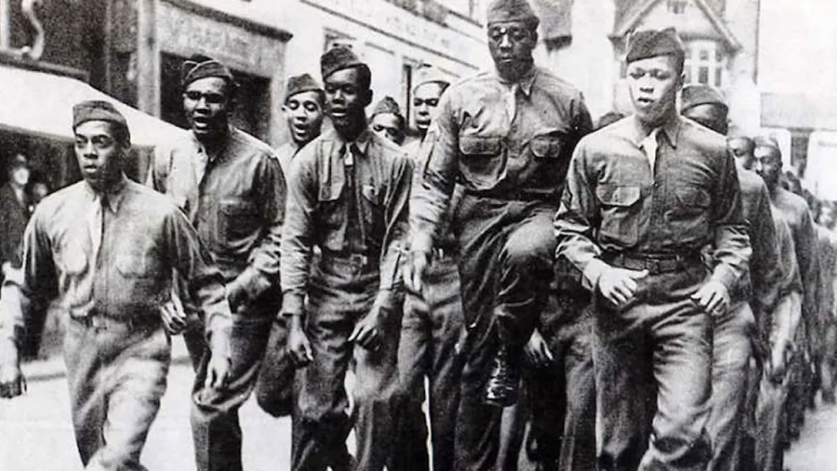 Group of African American soldiers marching in uniform, highlighting important aspects of African American military history.