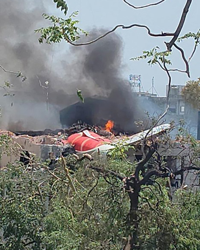 Smoke and flames rise from the wreckage of an Air India plane before crash, possibly revealing cause of accident.