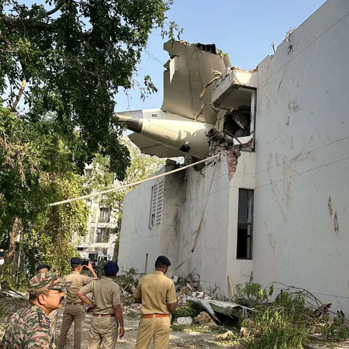 Air India survivor's guilt shown with plane wreckage inside a damaged building and officials inspecting the site. Air India survivor's guilt shown with plane wreckage inside a damaged building and officials inspecting the site.