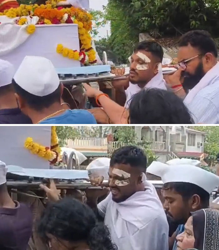 Man with bandages on face carrying decorated coffin during Air India survivor's funeral procession expressing survivor's guilt. Man with bandages on face carrying decorated coffin during Air India survivor's funeral procession expressing survivor's guilt.