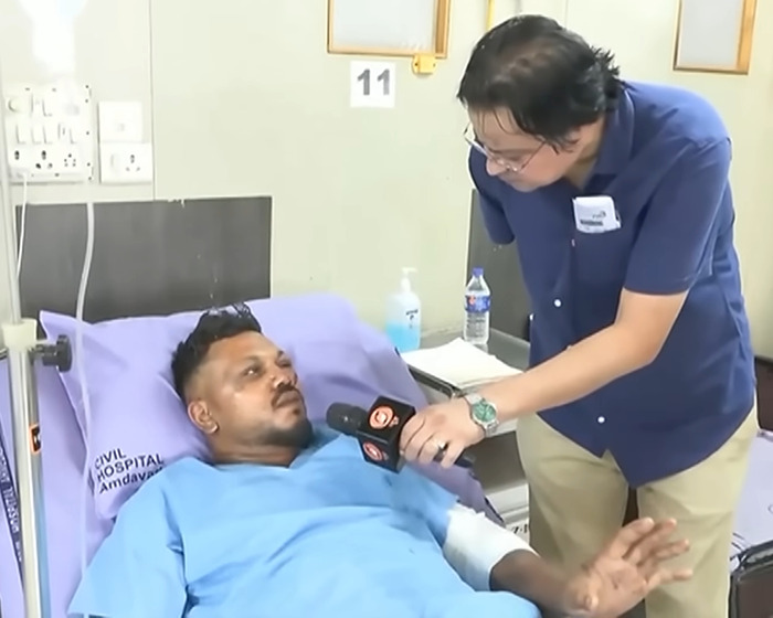 Man in hospital bed being interviewed about sole survivor of Air India crash performing a heartbreaking final act for brother. Man in hospital bed being interviewed about sole survivor of Air India crash performing a heartbreaking final act for brother.