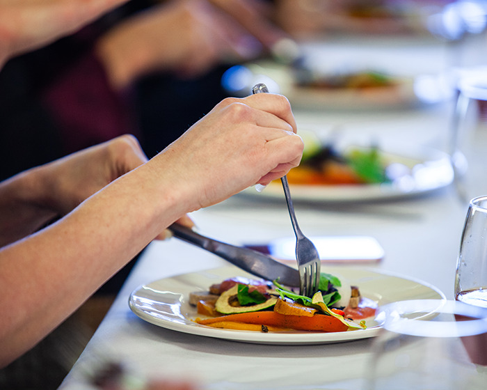 Person using cutlery to eat a meal, illustrating Americans criticized by Europeans for primitive way of eating with cutlery. Person using cutlery to eat a meal, illustrating Americans criticized by Europeans for primitive way of eating with cutlery.