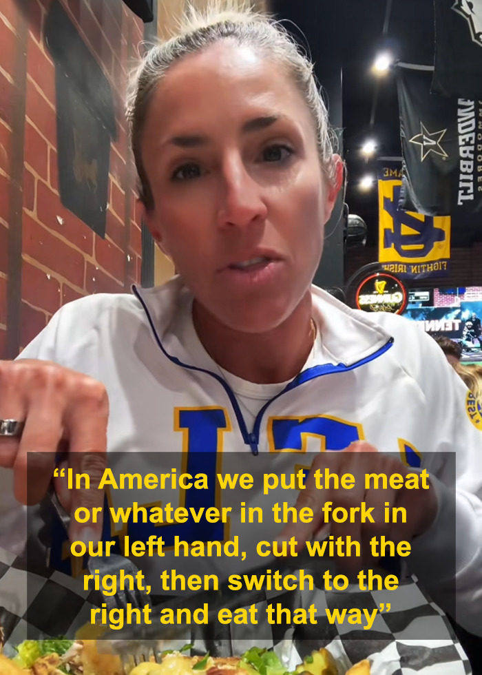Woman explaining American eating habits with cutlery at a restaurant, highlighting primitive way of eating with fork and knife. Woman explaining American eating habits with cutlery at a restaurant, highlighting primitive way of eating with fork and knife.