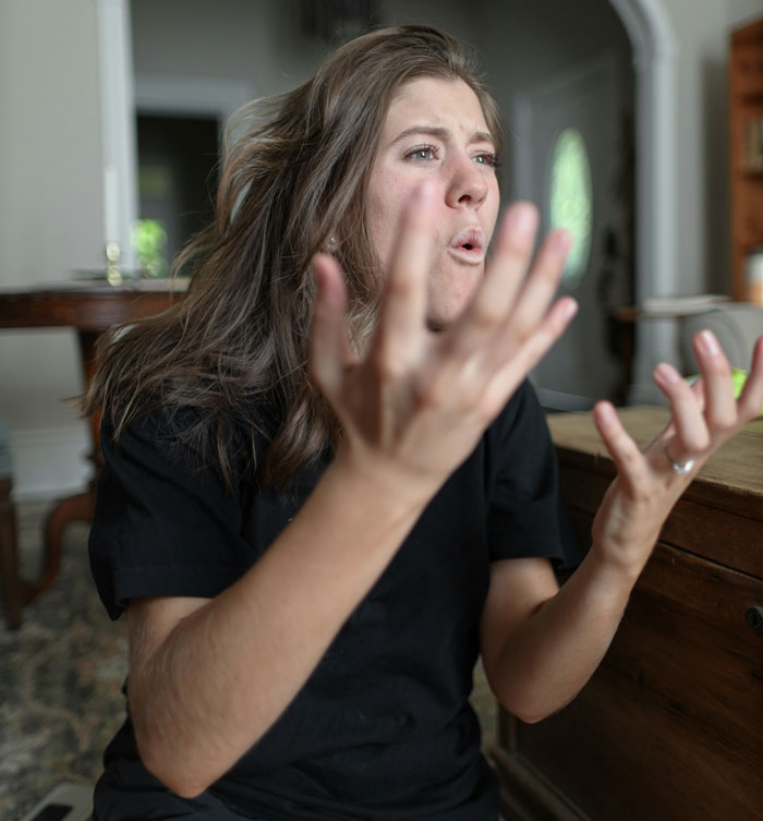 Woman expressing frustration indoors, illustrating wife threatening husband with cold shower due to his bad memory. Woman expressing frustration indoors, illustrating wife threatening husband with cold shower due to his bad memory.