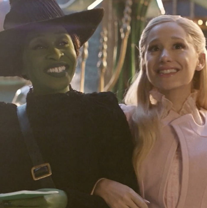 Two women smiling, one with entirely visible ribcage makeup in a ghoulish style from Wicked trailer. Two women smiling, one with entirely visible ribcage makeup in a ghoulish style from Wicked trailer.