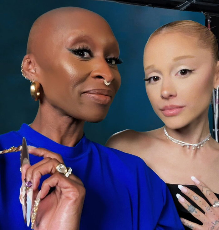 Two women posing closely together with dramatic makeup, highlighting Ariana Grande's entirely visible ribcage look. Two women posing closely together with dramatic makeup, highlighting Ariana Grande's entirely visible ribcage look.