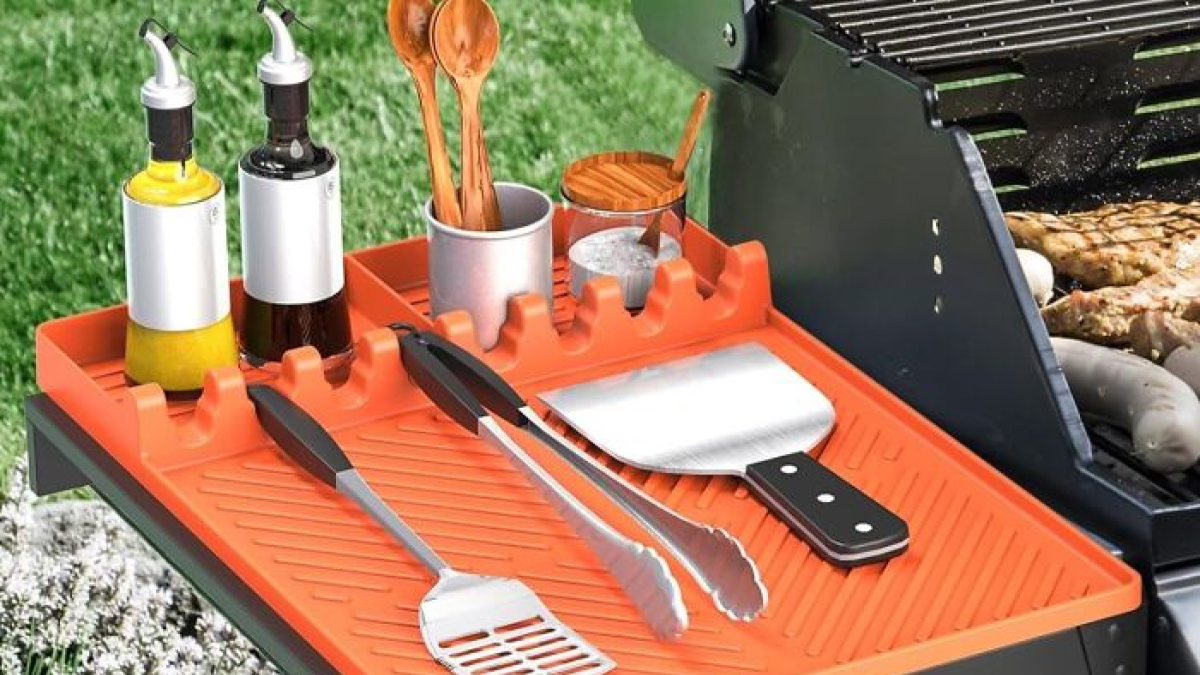 Outdoor grill setup with utensils and condiments on an orange tray, highlighting top finds for executive order ideas.