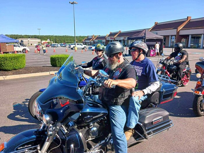 A dad and riders on motorcycles gathered outdoors, symbolizing a heartfelt story of a late son's heartbeat in a teddy bear.