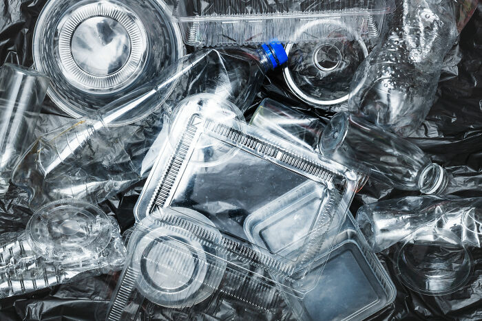 Pile of discarded clear plastic containers and bottles.