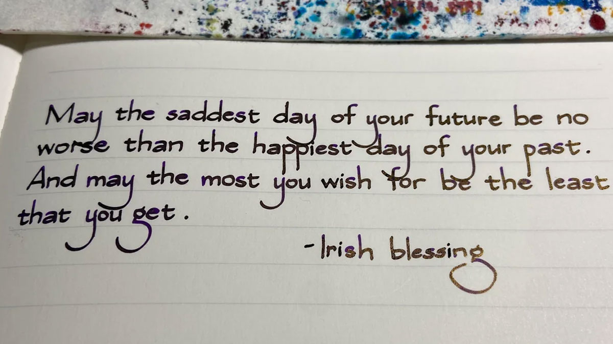 Handwriting that looks unreal with a neat, artistic style displaying an Irish blessing written on lined paper.