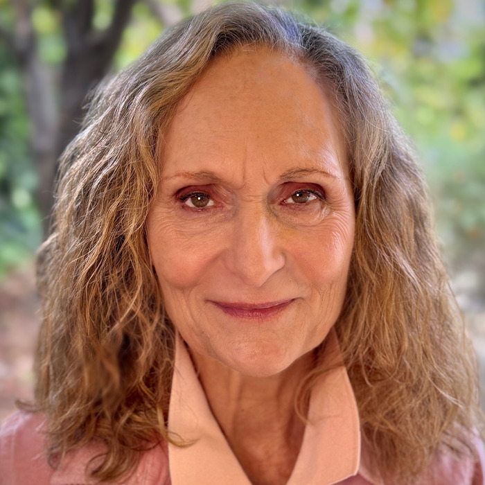 Older woman, beloved 90s star and Rain Man co-star, smiling outdoors with natural curly hair and soft lighting. Older woman, beloved 90s star and Rain Man co-star, smiling outdoors with natural curly hair and soft lighting.