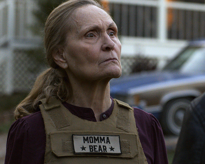 Elderly woman wearing a Momma Bear vest, portraying a beloved 90s star and Rain Man co-star unrecognizable 37 years later. Elderly woman wearing a Momma Bear vest, portraying a beloved 90s star and Rain Man co-star unrecognizable 37 years later.