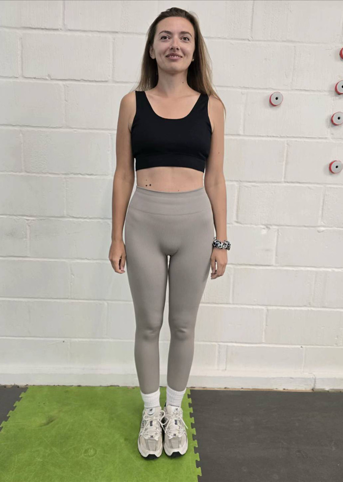 Slim woman standing in workout clothes against white wall, illustrating weight loss and Mounjaro side effects experience. Slim woman standing in workout clothes against white wall, illustrating weight loss and Mounjaro side effects experience.