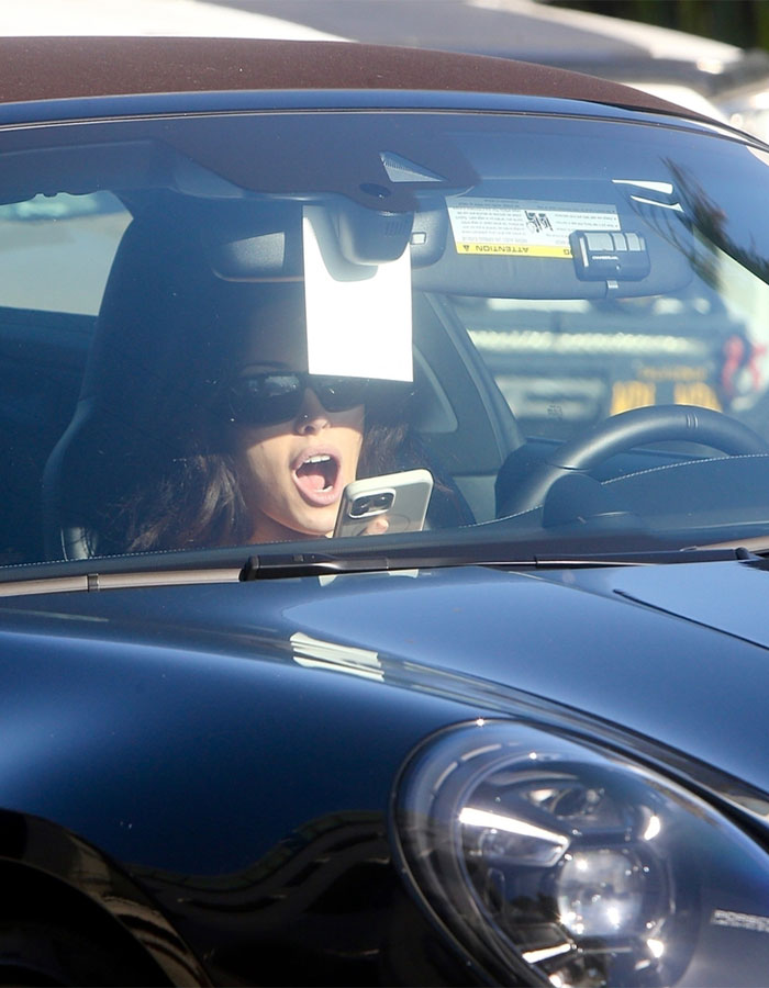 Woman allegedly infringing law again using phone while driving her black Porsche with sunglasses on inside the car. Woman allegedly infringing law again using phone while driving her black Porsche with sunglasses on inside the car.