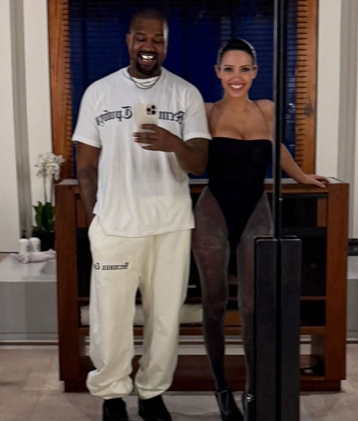 Kanye West and Bianca Censori smiling in a mirror selfie, highlighting Kanye West's wife Bianca Censori. Kanye West and Bianca Censori smiling in a mirror selfie, highlighting Kanye West's wife Bianca Censori.