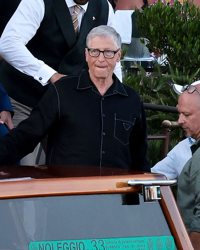 Man in black pajama-style shirt at an outdoor event, capturing the racy revealing looks from Jeff Bezos and Lauren Sánchez's afterparty. Man in black pajama-style shirt at an outdoor event, capturing the racy revealing looks from Jeff Bezos and Lauren Sánchez's afterparty.