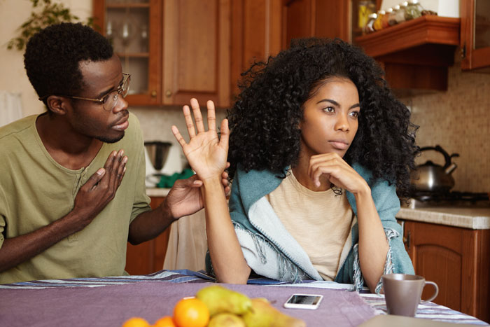 Teacher in kitchen refusing to talk as family member tries to explain, showing conflict and frustration at home. Teacher in kitchen refusing to talk as family member tries to explain, showing conflict and frustration at home.