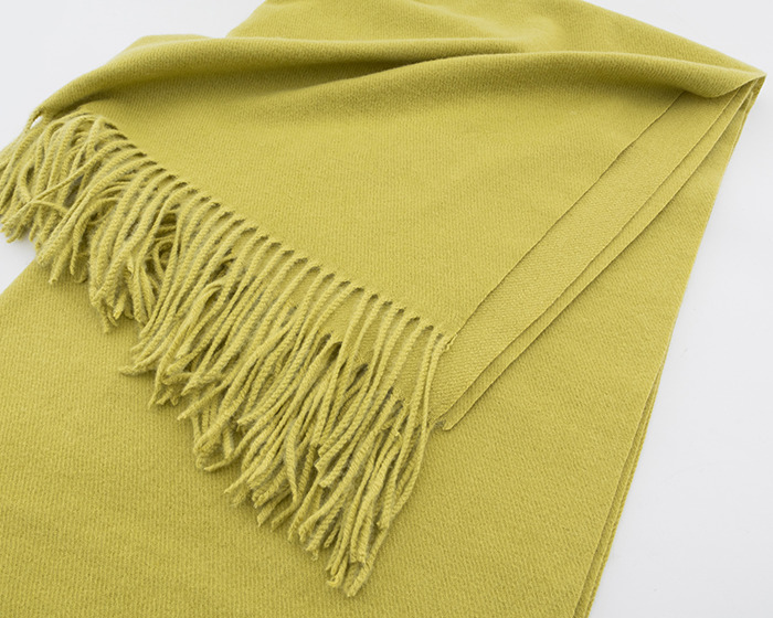Yellow wool scarf with fringed edges folded neatly on a white surface related to viral scarf challenge safety. Yellow wool scarf with fringed edges folded neatly on a white surface related to viral scarf challenge safety.