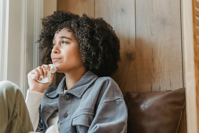Young woman with curly hair crying while sitting alone, capturing the bride’s dream bachelorette turning into a lonely cry-fest. Young woman with curly hair crying while sitting alone, capturing the bride’s dream bachelorette turning into a lonely cry-fest.