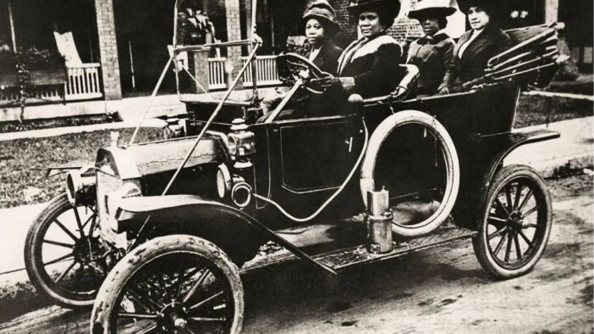 Four people of color seated in a vintage car, highlighting world-changing inventions by people of color in everyday life.