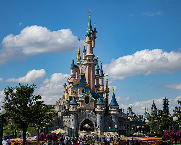 Disneyland castle with blue sky and visitors, related to man arrested for disturbing criminal record at Disneyland wedding. Disneyland castle with blue sky and visitors, related to man arrested for disturbing criminal record at Disneyland wedding.