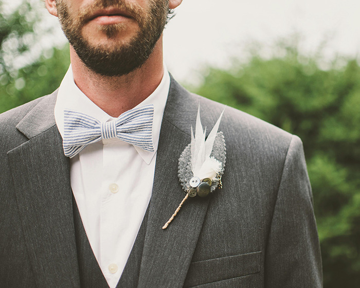 Man in gray suit and striped bow tie with boutonniere, representing man arrested for disturbing criminal record case. Man in gray suit and striped bow tie with boutonniere, representing man arrested for disturbing criminal record case.
