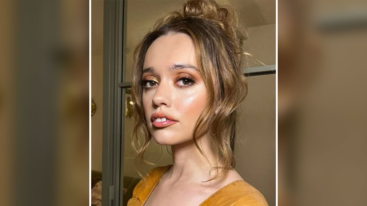Young woman with a unique facial quirk posing indoors, embracing her gloriously unique quirks with confidence.