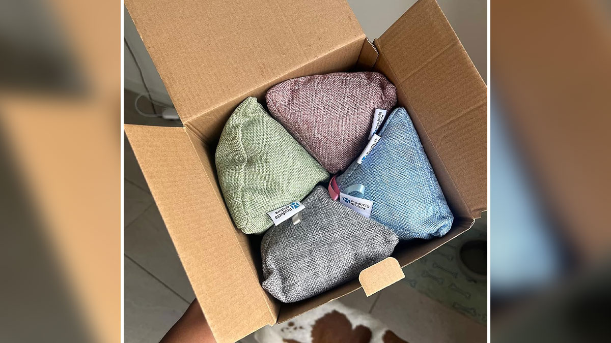 Open cardboard box with colorful chemical-free cleaning pouches made of textured fabric inside.