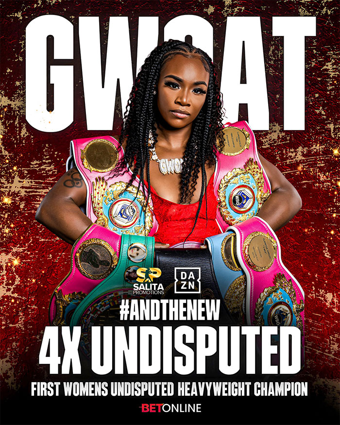 Claressa Shields confidently posing with multiple boxing championship belts showcasing her net worth as a boxing champ.