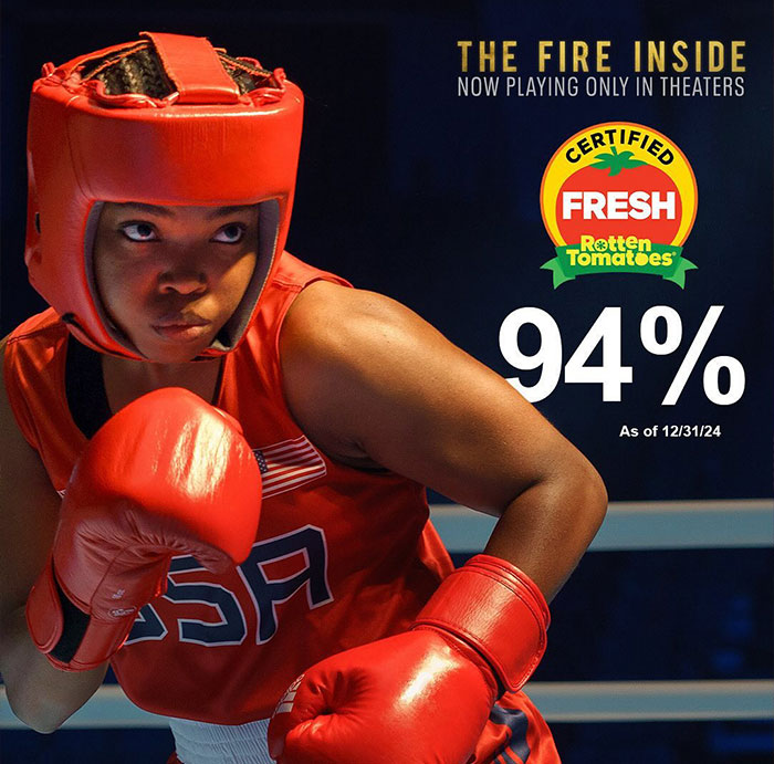 Female boxer Claressa Shields in red gear with gloves and helmet preparing to punch, representing Claressa Shields net worth in boxing.