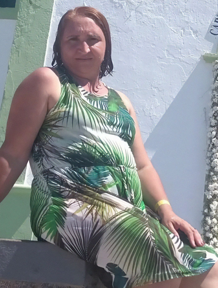 Woman posing outdoors in a tropical dress before transformation into bodybuilding champion at age 53. Woman posing outdoors in a tropical dress before transformation into bodybuilding champion at age 53.