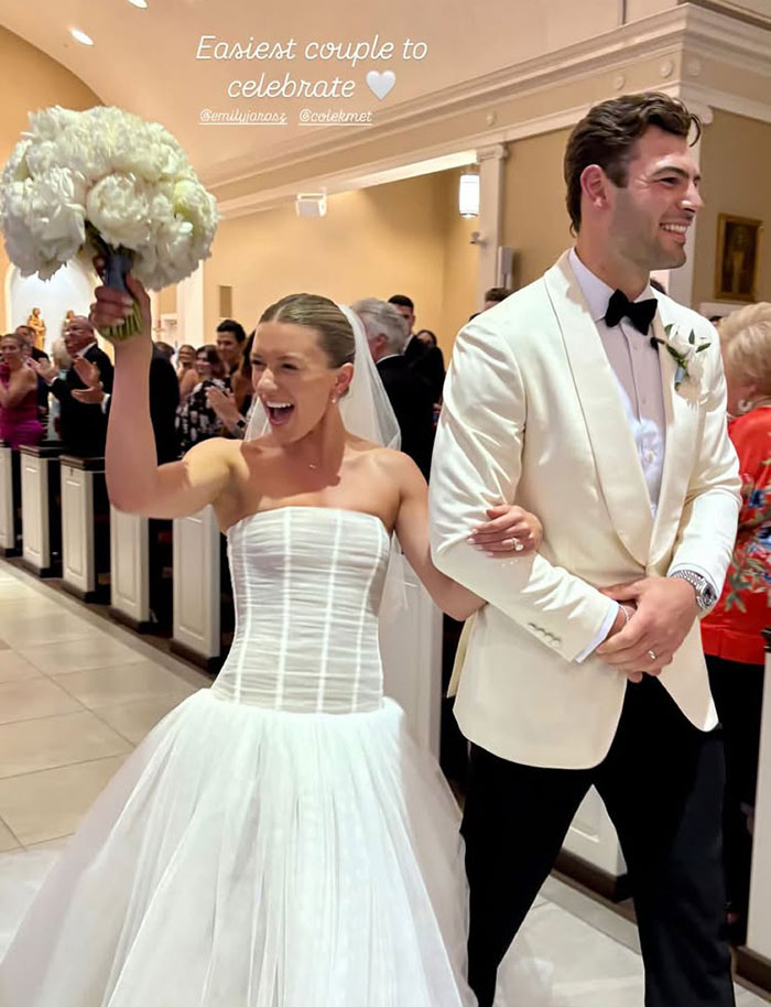Bride in white wedding dress holding bouquet and groom in white tuxedo smiling, sparking rumors of Taylor Swift and Travis Kelce marriage. Bride in white wedding dress holding bouquet and groom in white tuxedo smiling, sparking rumors of Taylor Swift and Travis Kelce marriage.