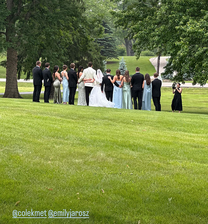 Group of people dressed for a wedding outdoors, possibly linked to Taylor Swift and Travis Kelce secret marriage rumors. Group of people dressed for a wedding outdoors, possibly linked to Taylor Swift and Travis Kelce secret marriage rumors.