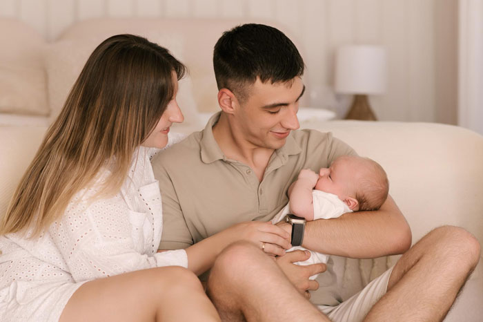 Young family bonding at home with newborn baby, symbolizing postpartum life after buying a 1972 Ford Bronco. Young family bonding at home with newborn baby, symbolizing postpartum life after buying a 1972 Ford Bronco.