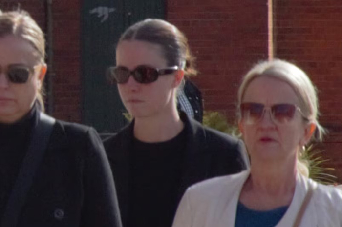 Woman wearing dark sunglasses walking outside with two other women, related to misogynistic comment case and lighter sentence request. Woman wearing dark sunglasses walking outside with two other women, related to misogynistic comment case and lighter sentence request.