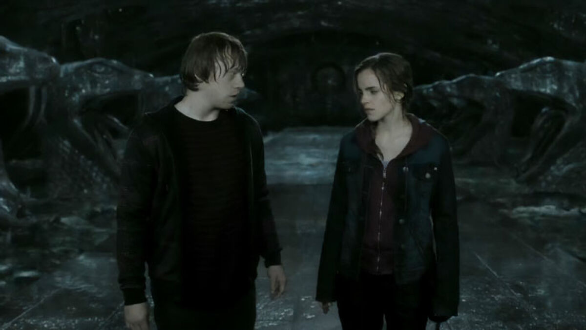 Emma Watson and Rupert Grint in a dark scene from Harry Potter, discussing controversy around an incest interpretation.
