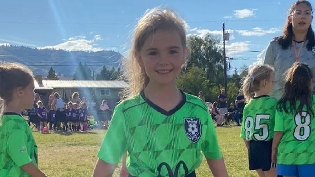 Three young sisters in green soccer uniforms playing outdoors before planned visitation with dad in a tragic passing case.