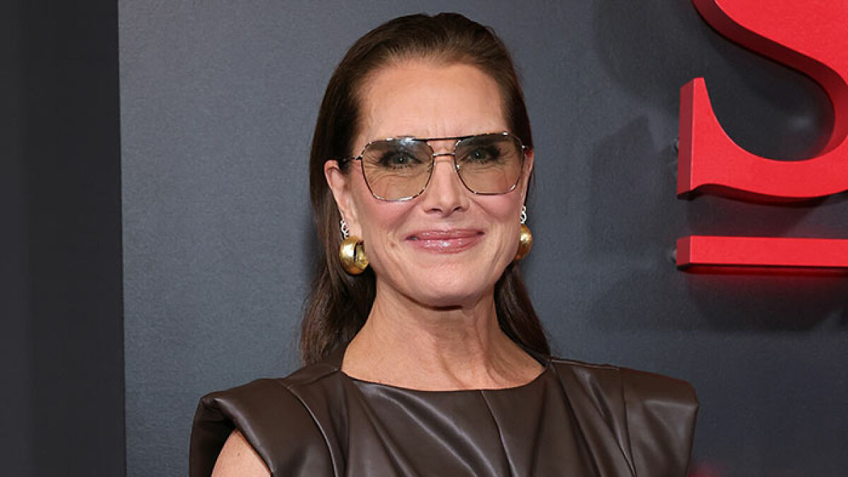 Brooke Shields wearing stylish glasses and gold earrings at an event discussing Meghan Markle podcast interview controversy.