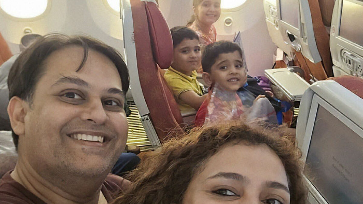 Family smiling for a selfie inside Air India plane just before disaster struck, capturing a final moment together on board.