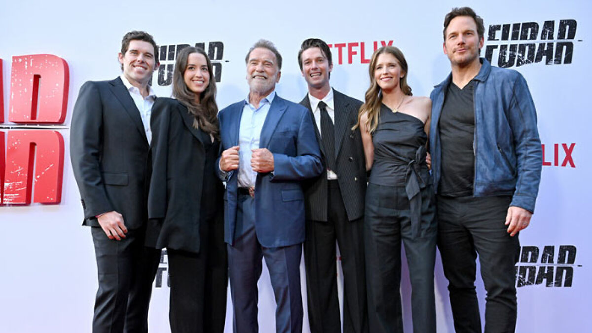Arnold Schwarzenegger with family members at a Netflix premiere event, posing on the red carpet together.