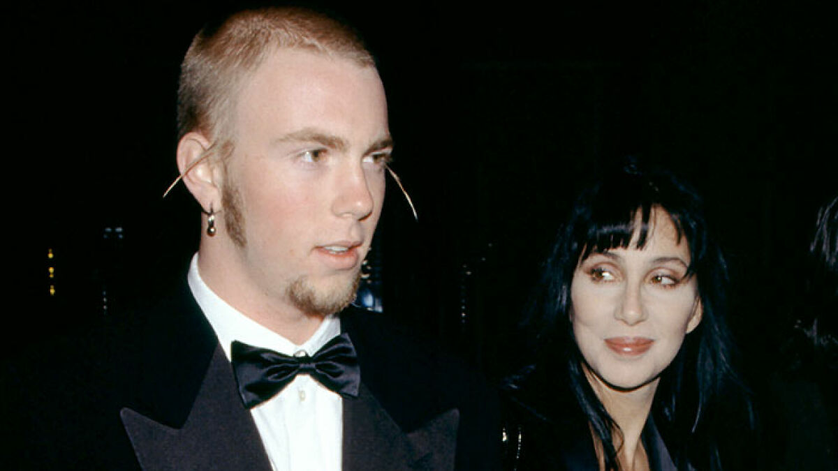 Cher looking concerned beside her son at a formal event amid alleged kidnap attempt and near-fatal o******e news.