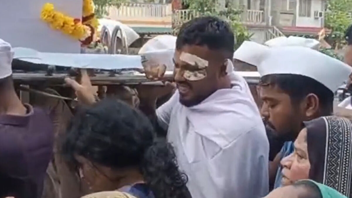 Man with bandaged eyes carrying brotheru2019s coffin in heartbreaking final act after Air India crash survivor gathers support.