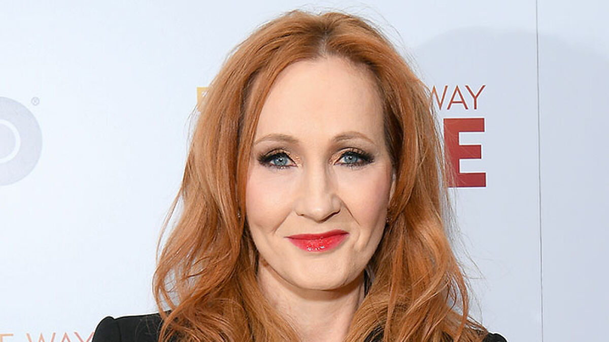 J.K. Rowling at an event with red hair and red lipstick, linked to Stephen Fry's brutal takedown commentary.