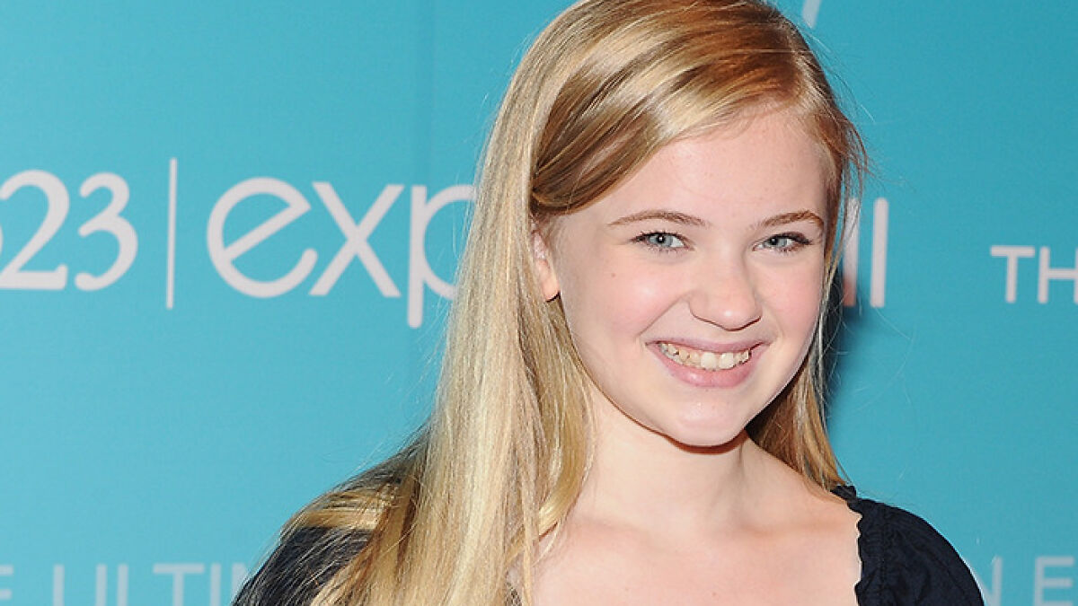 Young child star smiling at a media event, showing unrecognizable transformation raising Disney pattern concerns.