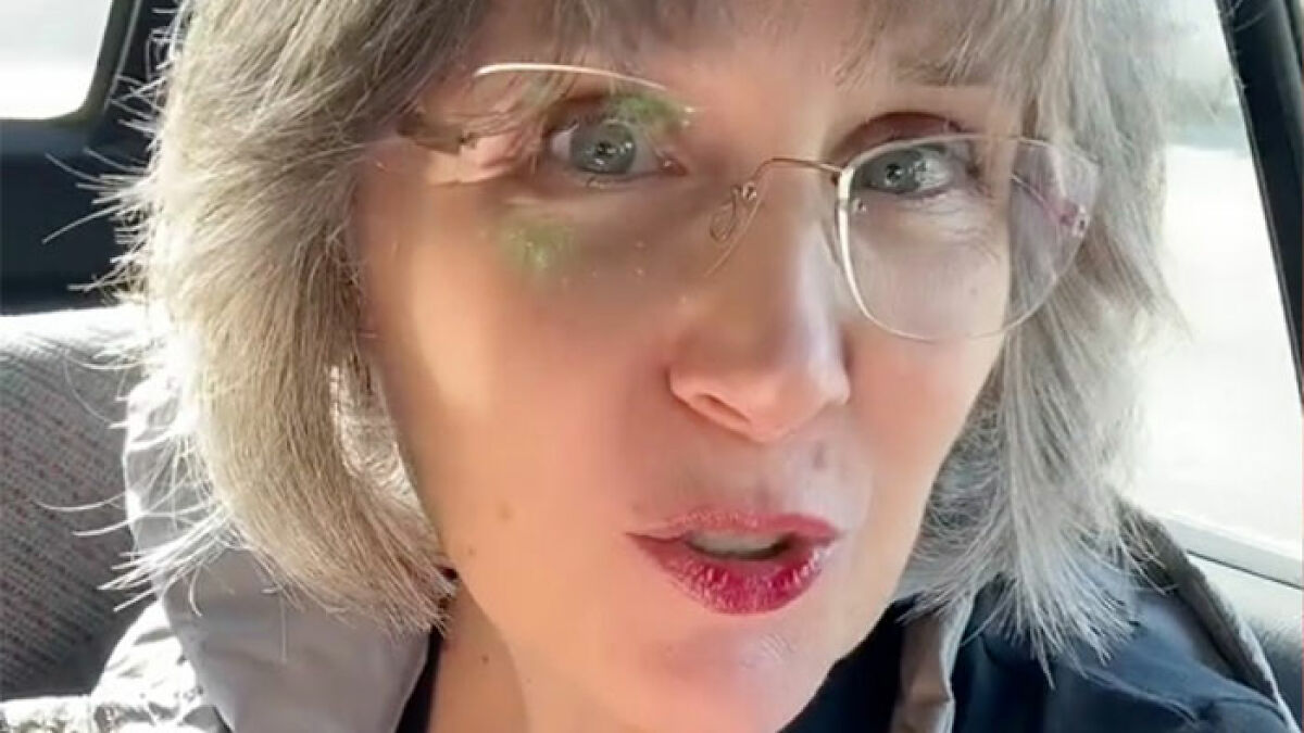 Close-up of a woman wearing glasses inside a car, related to momu2019s insulting birthday gift backlash story.