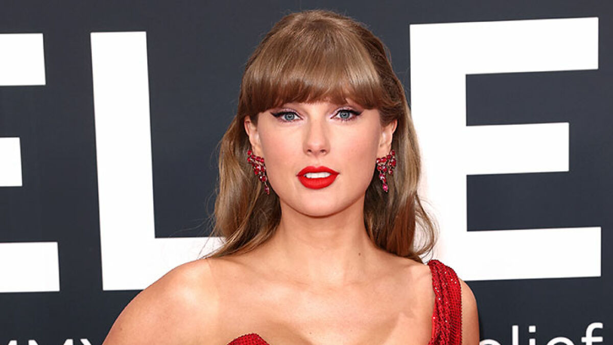 Taylor Swift in a red dress and earrings posing at an event, relating to the pushy influencer rejection story.