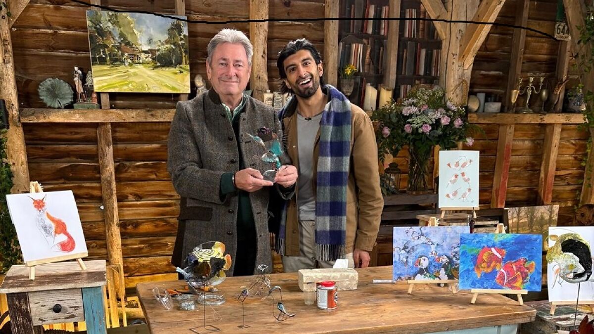 Alan Titchmarsh with a wildlife artist showcasing detailed bird sculptures and paintings in a rustic wooden studio.