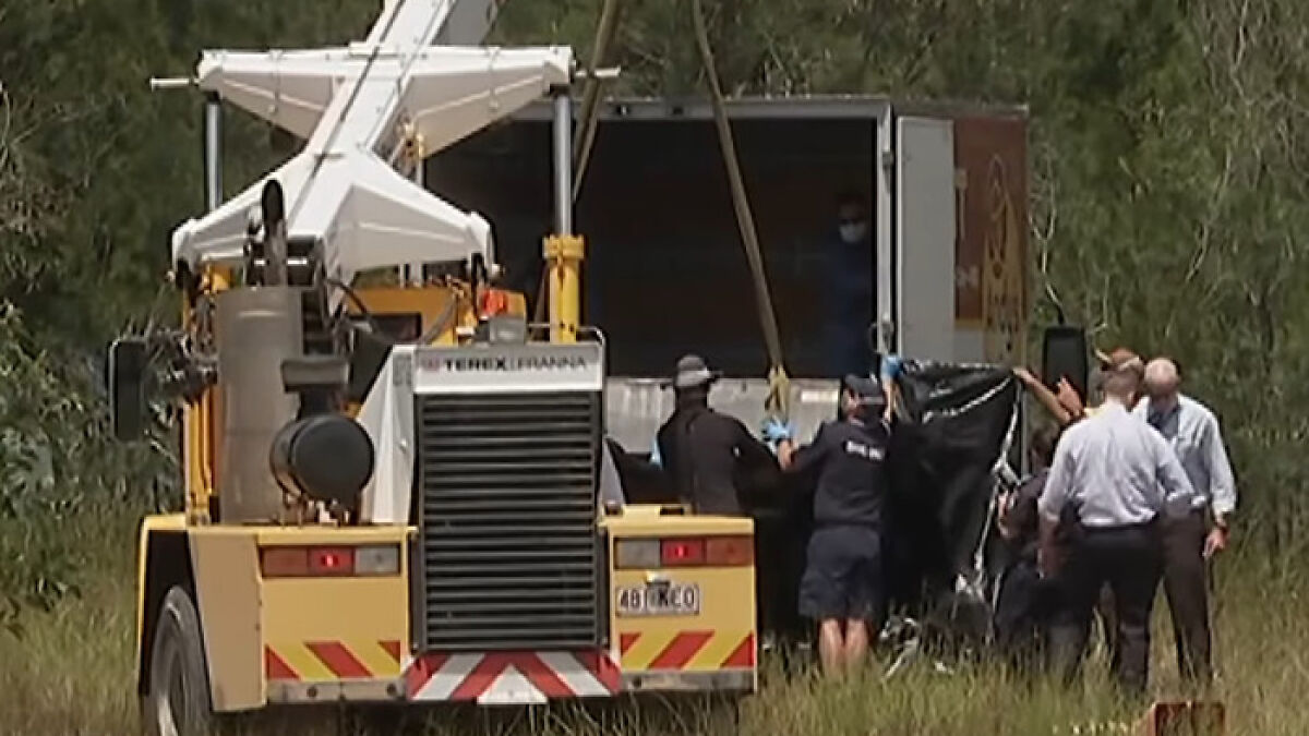 Three men involved in brutalizing victims are led away as authorities investigate a crime scene with a large toolbox.