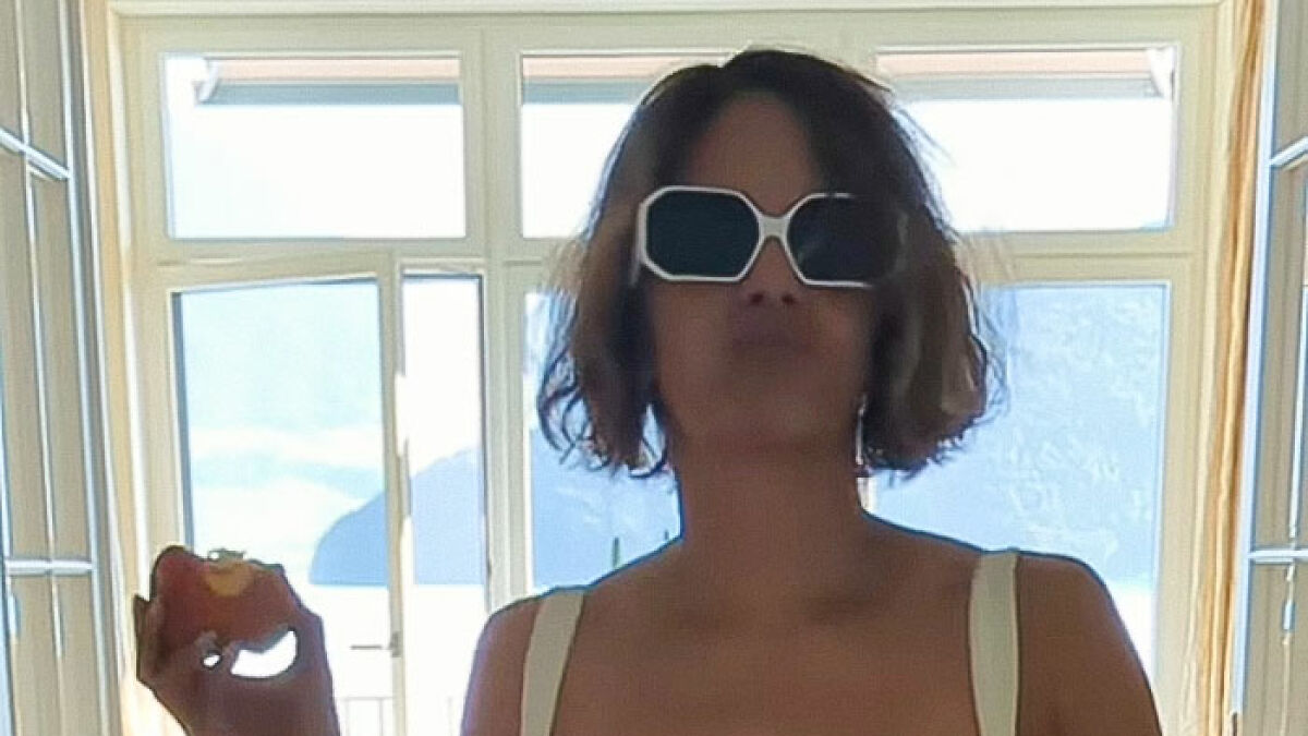 Halle Berry in sunglasses at home, experiencing a funny bikini malfunction while dancing to boyfriendu2019s song.